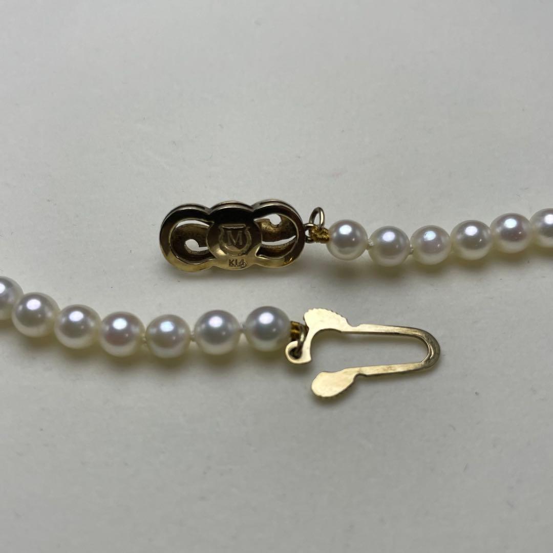 Mikimoto Akoya pearls necklace featuring white 4.5-8.5mm pearls with K14 clasp and pinkish natural interference color