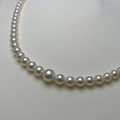 Mikimoto Akoya pearls necklace featuring white 4.5-8.5mm pearls with K14 clasp and pinkish natural interference color