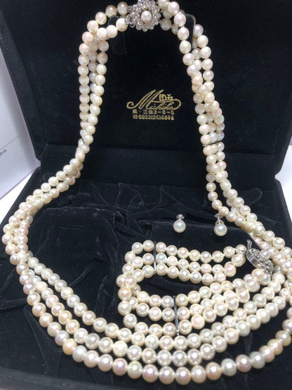 Akoya pearl silver necklace, bracelet, and earrings set with white pearls and sterling silver accents