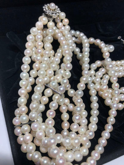 Akoya pearl silver necklace, bracelet, and earrings set with white pearls and sterling silver accents