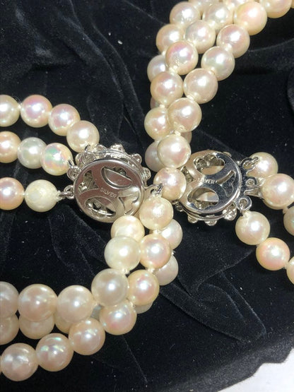 Akoya pearl silver necklace, bracelet, and earrings set with white pearls and sterling silver accents