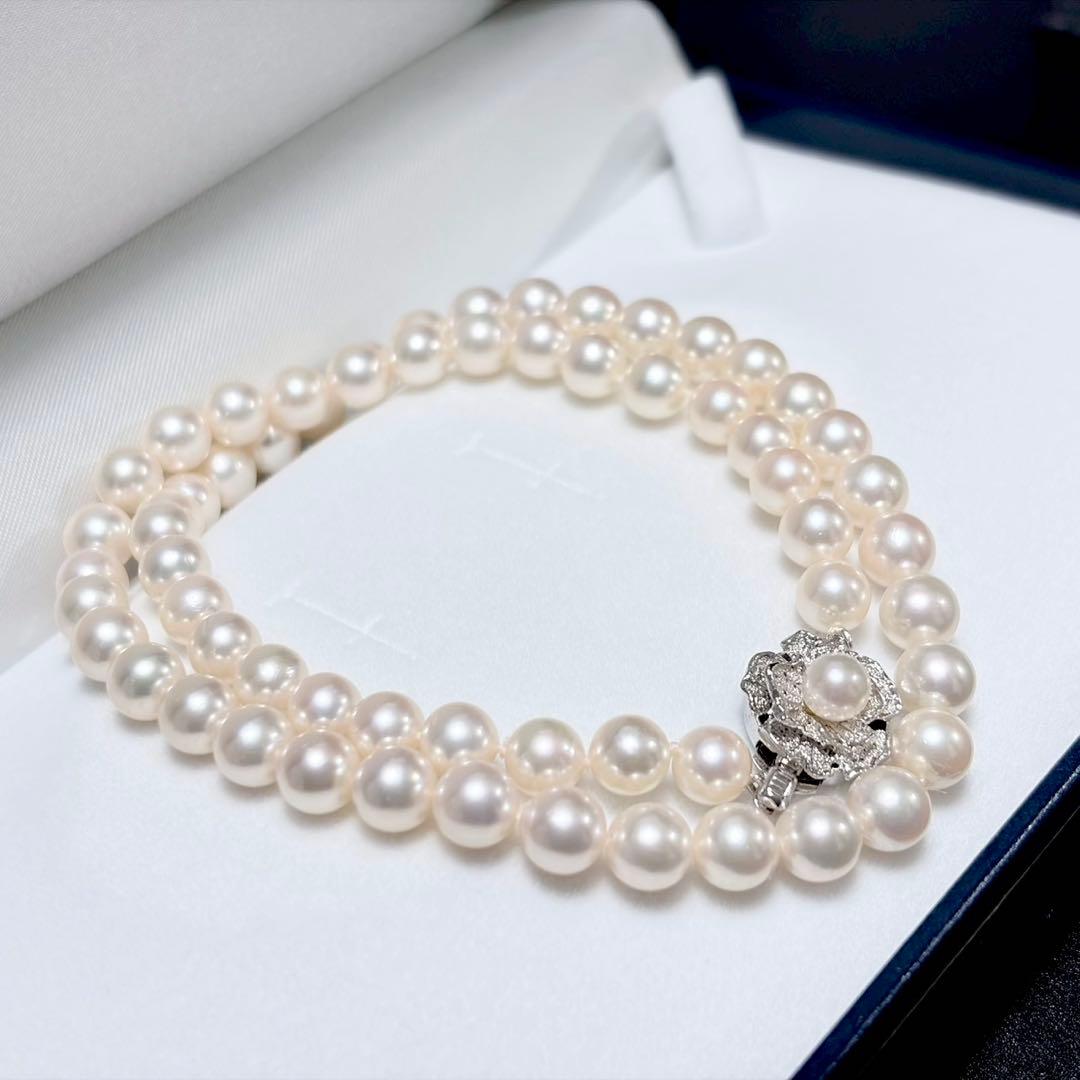 Akoya pearl necklace with white 6.5-6.9mm pearls and silver clasp on a white background