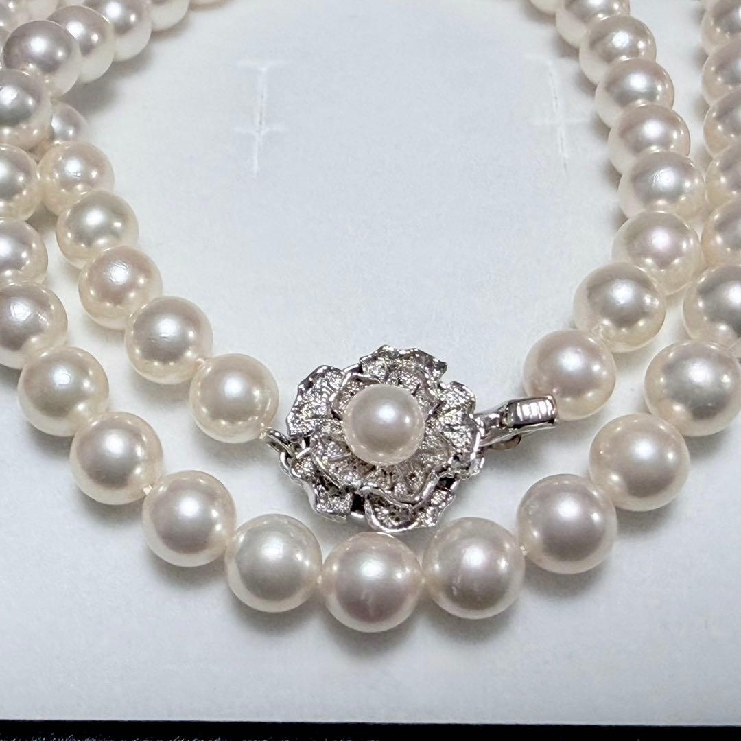 Akoya pearl necklace with white 6.5-6.9mm pearls and silver clasp on a white background