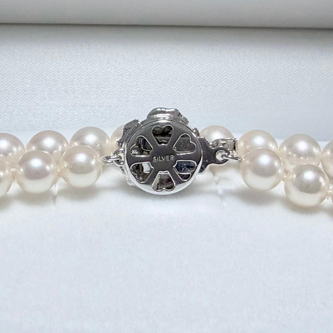 Akoya pearl necklace with white 6.5-6.9mm pearls and silver clasp on a white background