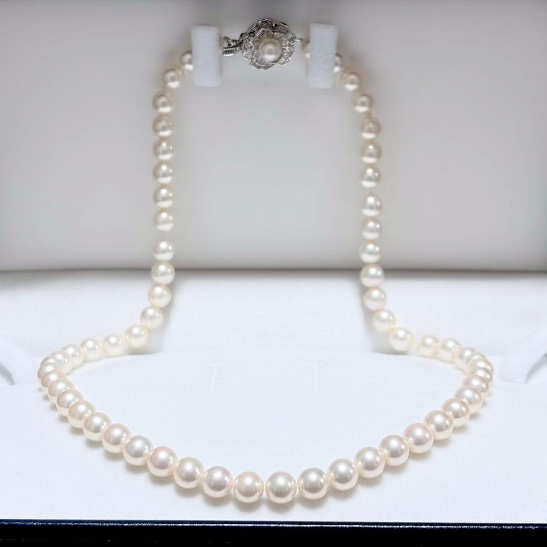 Akoya pearl necklace with white 6.5-6.9mm pearls and silver clasp on a white background