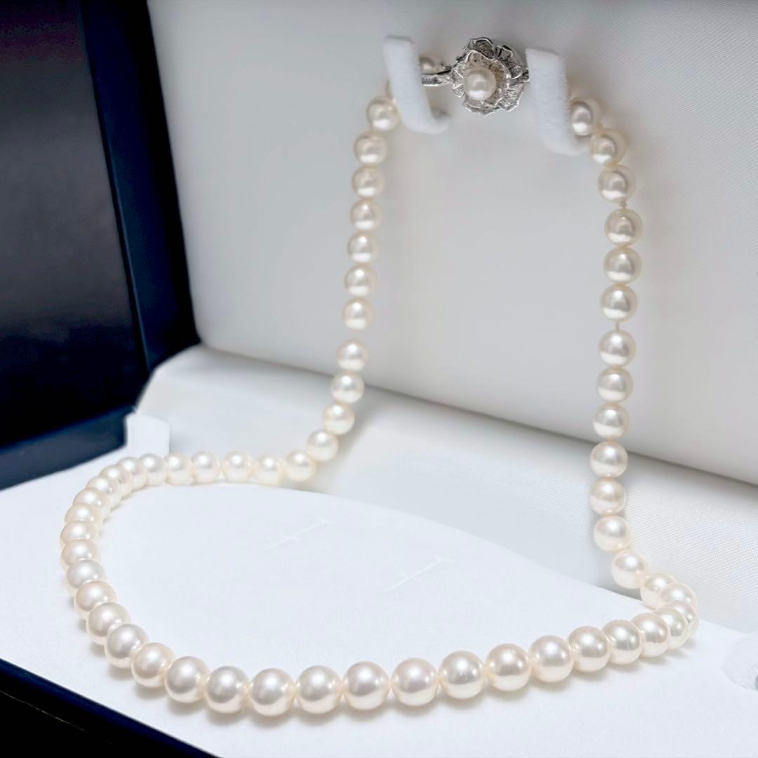Akoya pearl necklace with white 6.5-6.9mm pearls and silver clasp on a white background