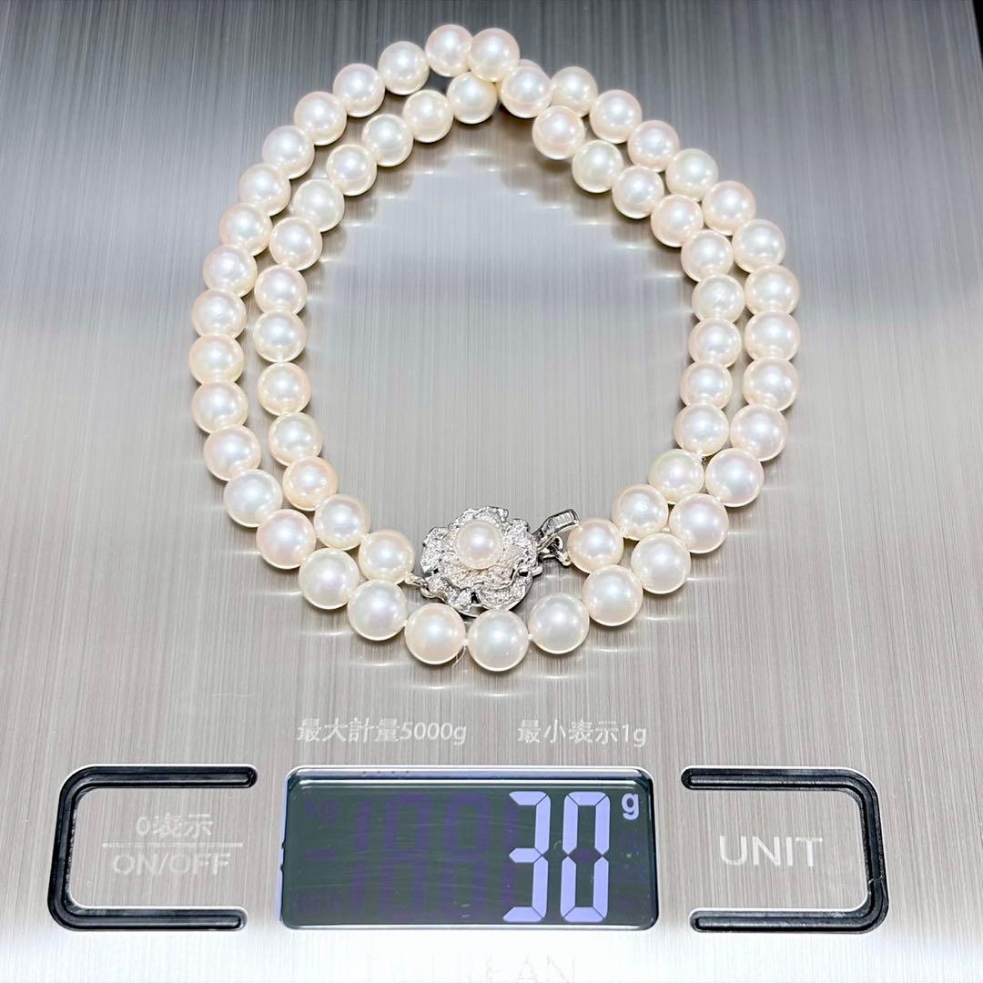 Akoya pearl necklace with white 6.5-6.9mm pearls and silver clasp on a white background