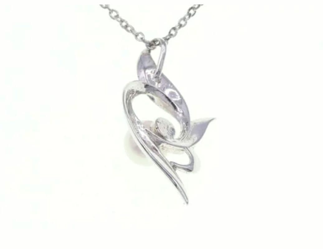 Mikimoto silver necklace with 5.9mm pearl, Nina Ricci heart motif necklace, Tocca blue handkerchief accessory and Snow Skin design