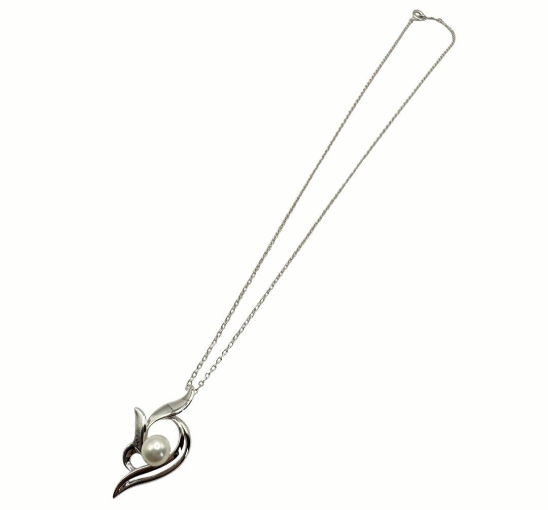 Mikimoto silver necklace with 5.9mm pearl, Nina Ricci heart motif necklace, Tocca blue handkerchief accessory and Snow Skin design