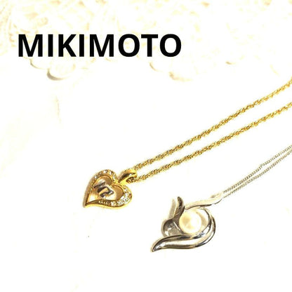 Mikimoto silver necklace with 5.9mm pearl, Nina Ricci heart motif necklace, Tocca blue handkerchief accessory and Snow Skin design