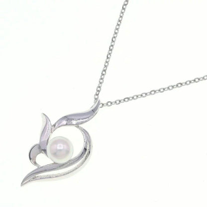 Mikimoto silver necklace with 5.9mm pearl, Nina Ricci heart motif necklace, Tocca blue handkerchief accessory and Snow Skin design