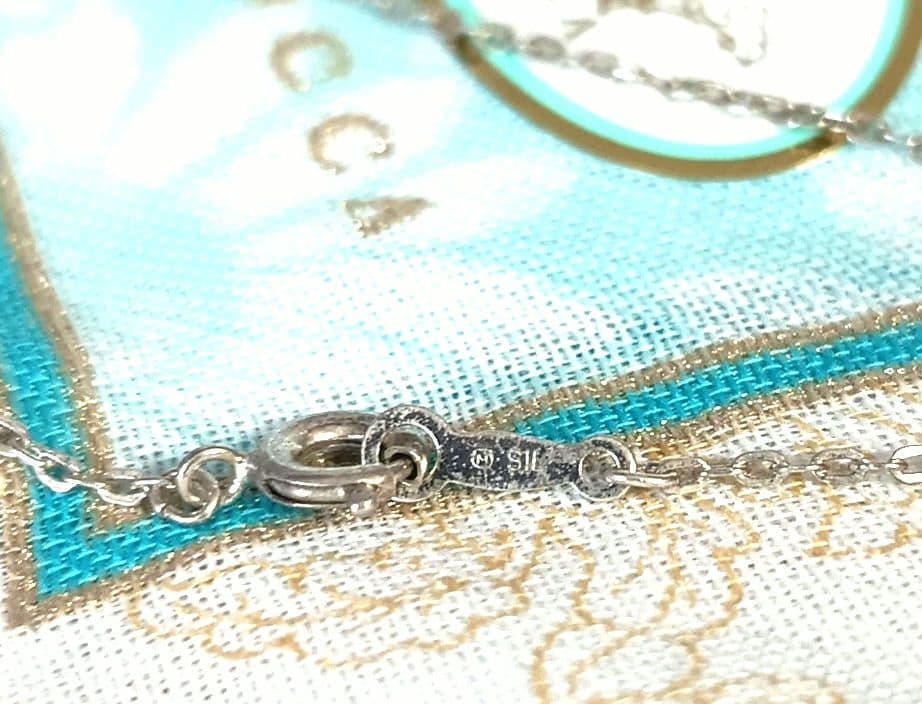 Mikimoto silver necklace with 5.9mm pearl, Nina Ricci heart motif necklace, Tocca blue handkerchief accessory and Snow Skin design