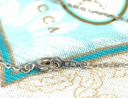 Mikimoto silver necklace with 5.9mm pearl, Nina Ricci heart motif necklace, Tocca blue handkerchief accessory and Snow Skin design
