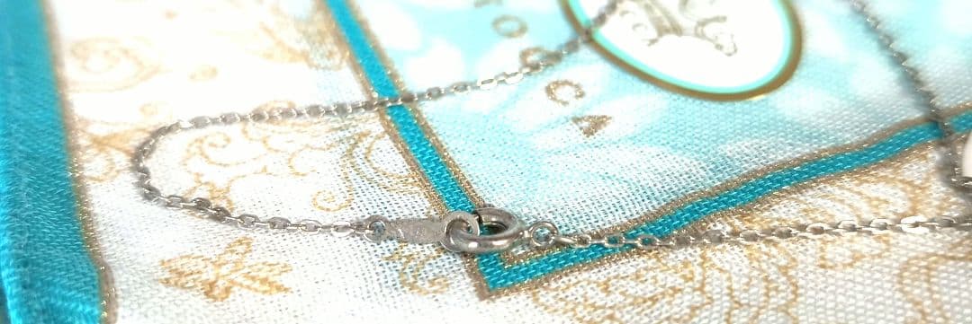 Mikimoto silver necklace with 5.9mm pearl, Nina Ricci heart motif necklace, Tocca blue handkerchief accessory and Snow Skin design