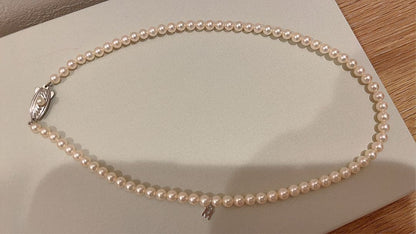 Mikimoto Akoya pearl necklace 43cm with 6.0−6.5mm pearls and silver clasp on white background