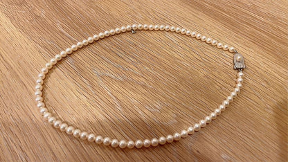 Mikimoto Akoya pearl necklace 43cm with 6.0−6.5mm pearls and silver clasp on white background