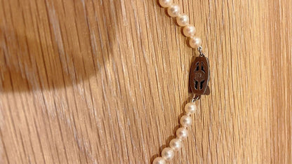 Mikimoto Akoya pearl necklace 43cm with 6.0−6.5mm pearls and silver clasp on white background