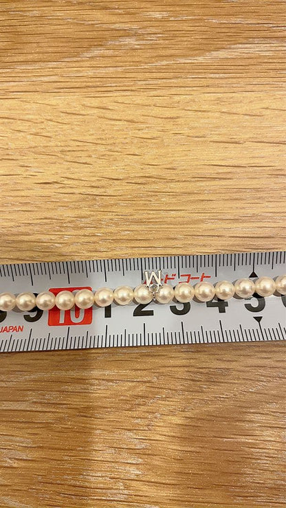 Mikimoto Akoya pearl necklace 43cm with 6.0−6.5mm pearls and silver clasp on white background