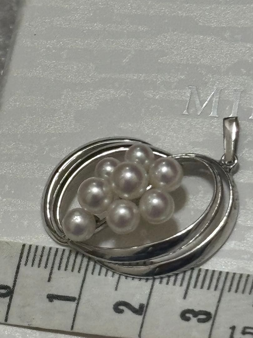 Mikimoto Pearl Pendant Top featuring 8 pearls in a circle motif with silver back stamp
