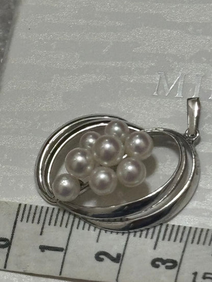 Mikimoto Pearl Pendant Top featuring 8 pearls in a circle motif with silver back stamp