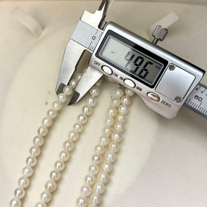 Two-strand necklace with white 5.5mm round Akoya baby pearls featuring silver mark