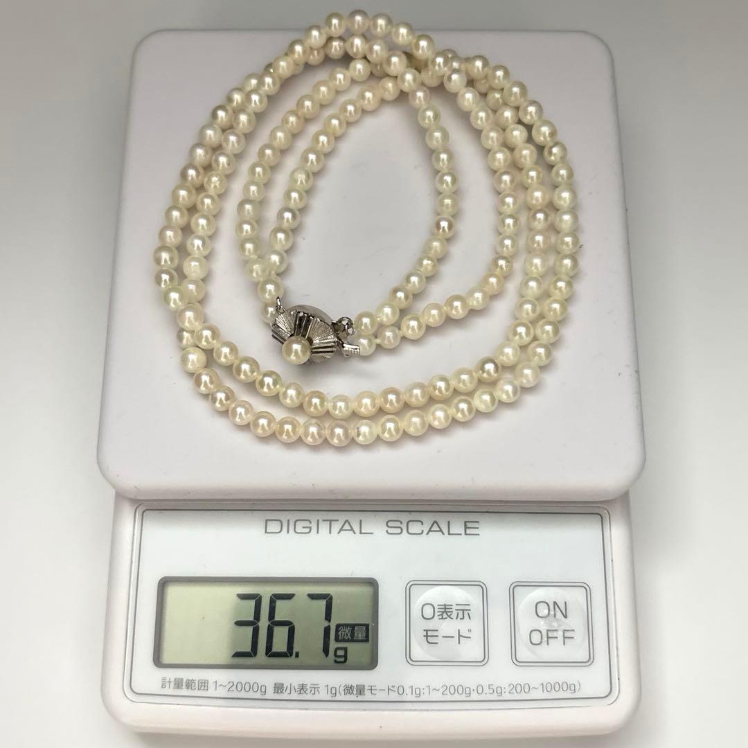 Two-strand necklace with white 5.5mm round Akoya baby pearls featuring silver mark