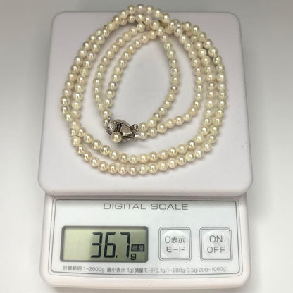 Two-strand necklace with white 5.5mm round Akoya baby pearls featuring silver mark