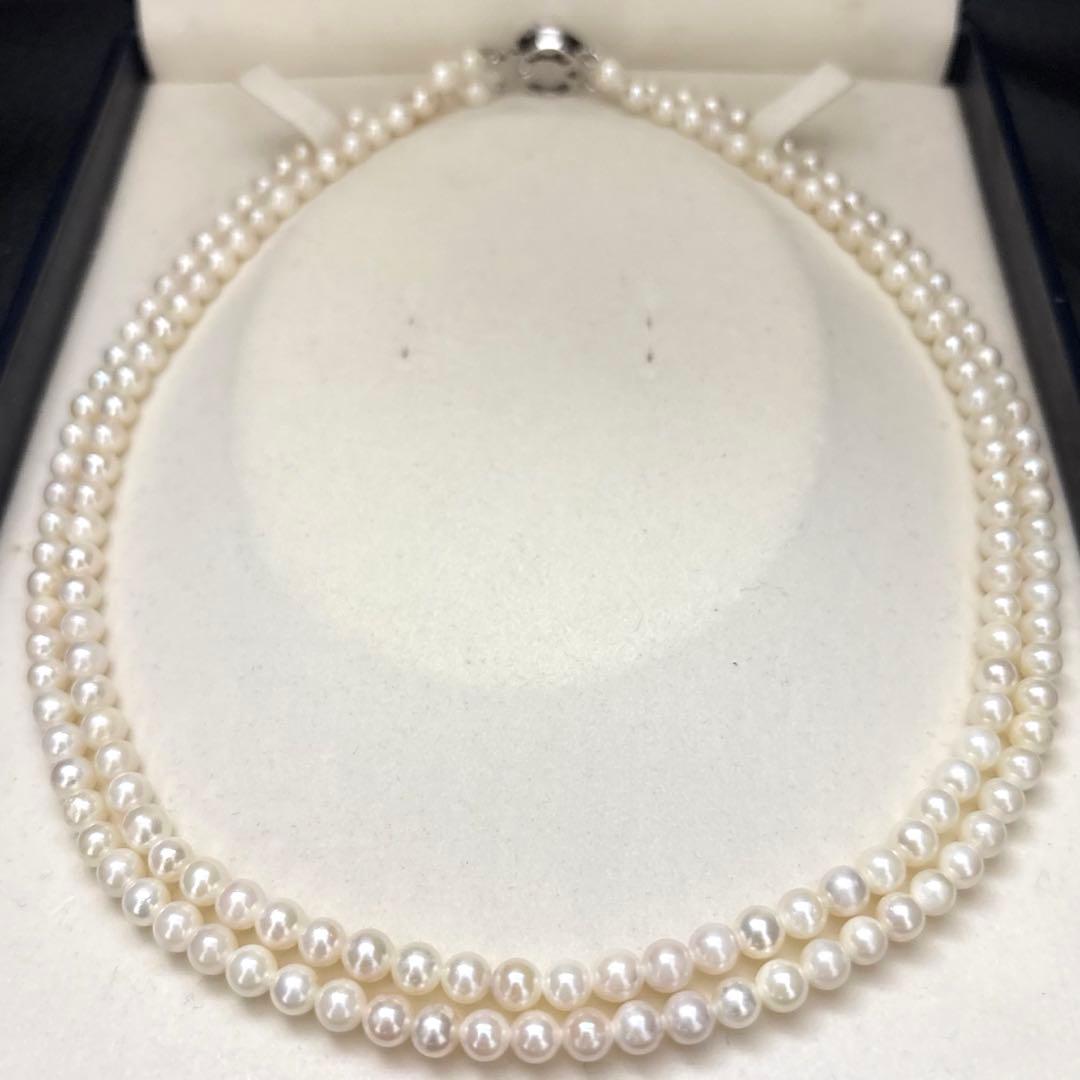Two-strand necklace with white 5.5mm round Akoya baby pearls featuring silver mark