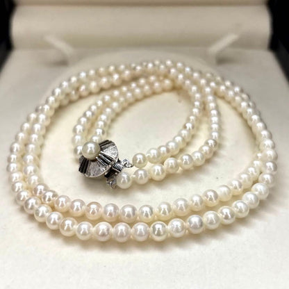 Two-strand necklace with white 5.5mm round Akoya baby pearls featuring silver mark