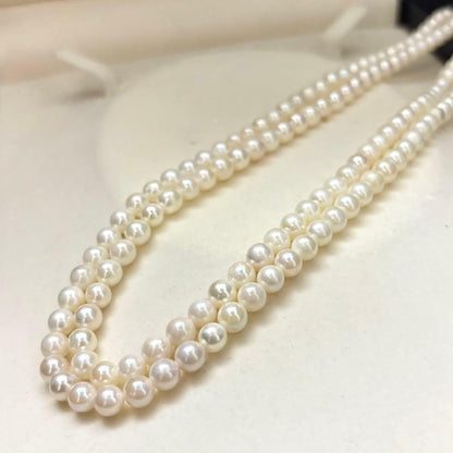 Two-strand necklace with white 5.5mm round Akoya baby pearls featuring silver mark