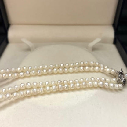 Two-strand necklace with white 5.5mm round Akoya baby pearls featuring silver mark