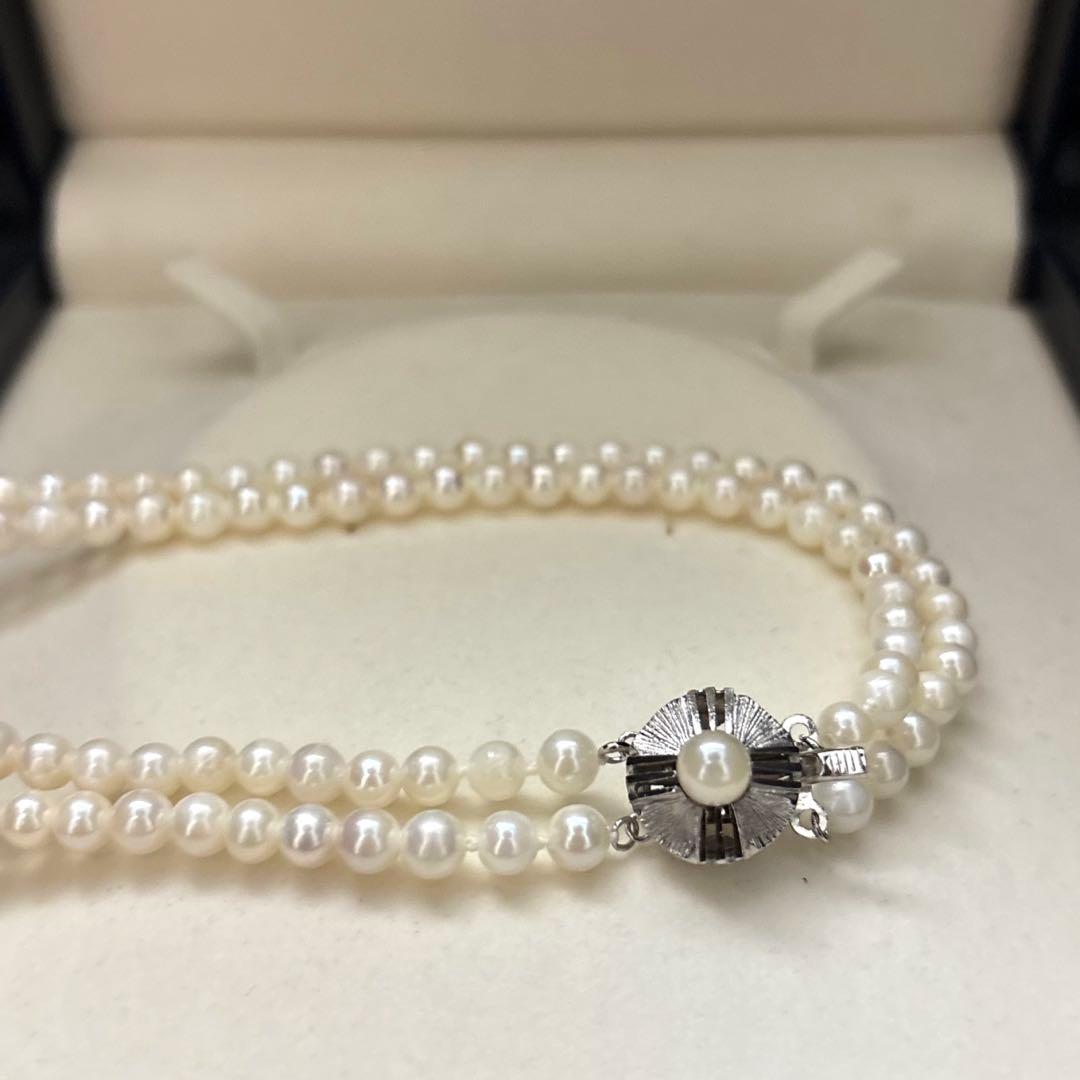 Two-strand necklace with white 5.5mm round Akoya baby pearls featuring silver mark