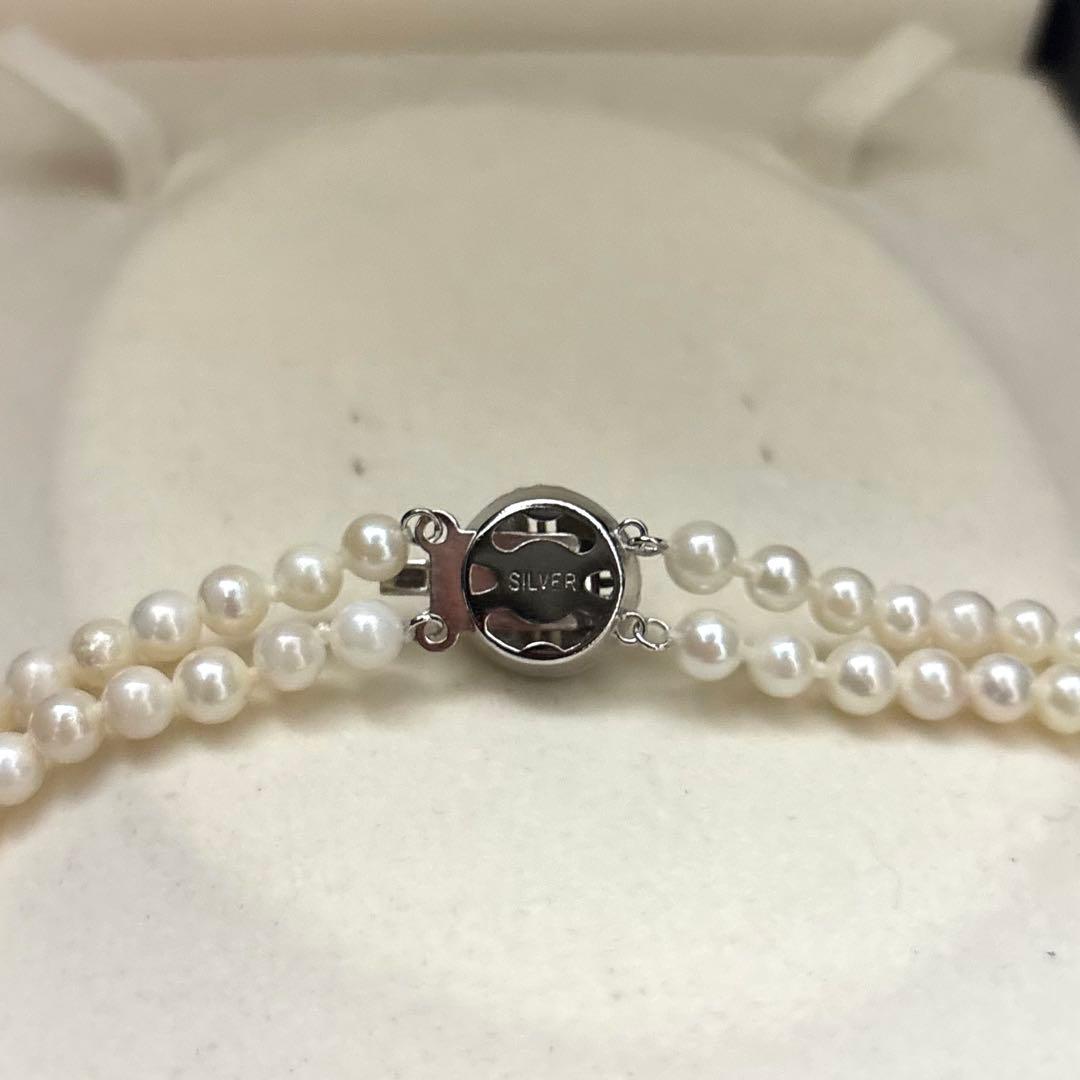 Two-strand necklace with white 5.5mm round Akoya baby pearls featuring silver mark