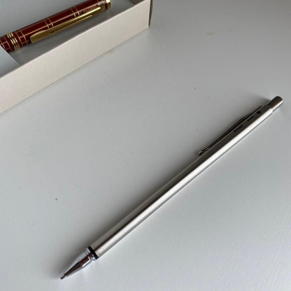 Pilot Pen mechanical pencil and ballpoint pen set with red pen and mechanical pencil showing signs of wear and dirt