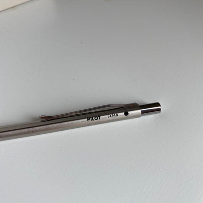 Pilot Pen mechanical pencil and ballpoint pen set with red pen and mechanical pencil showing signs of wear and dirt