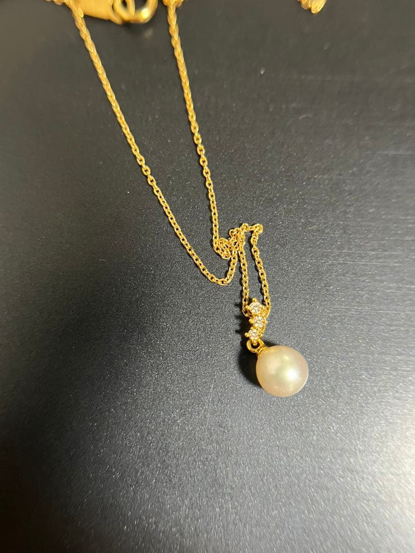 TASAKI Akoya pearl necklace with diamond accents in 18K gold on a white background