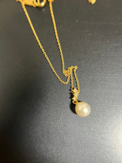 TASAKI Akoya pearl necklace with diamond accents in 18K gold on a white background