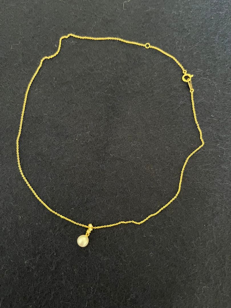 TASAKI Akoya pearl necklace with diamond accents in 18K gold on a white background