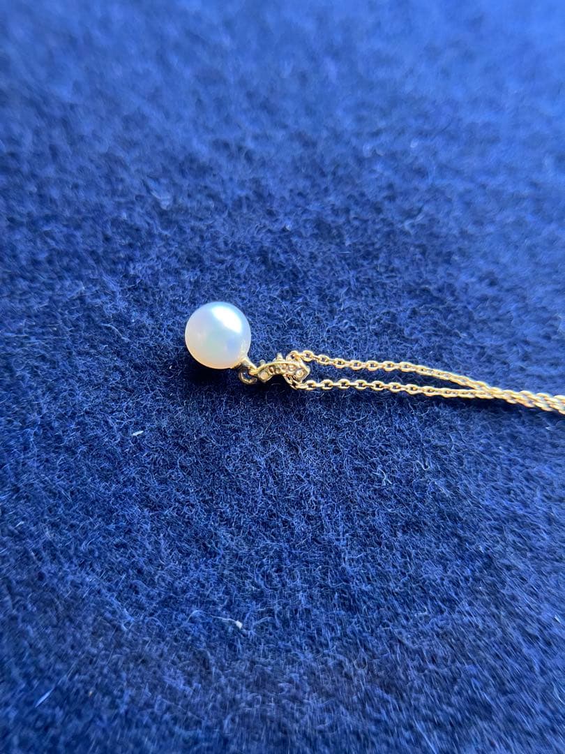 TASAKI Akoya pearl necklace with diamond accents in 18K gold on a white background