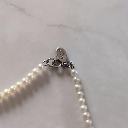 Agete white pearl necklace with lobster clasp, 110 cm long, featuring lustrous white pearls