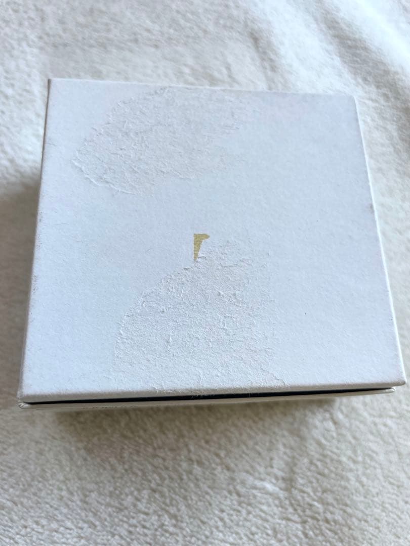 Used Tasaki pearl necklace with original box showing peeling and fading at bottom