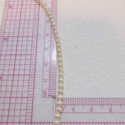 14K gold clasp Akoya baby pearl necklace with 2.8 to 3.3mm pearls on a 40cm chain
