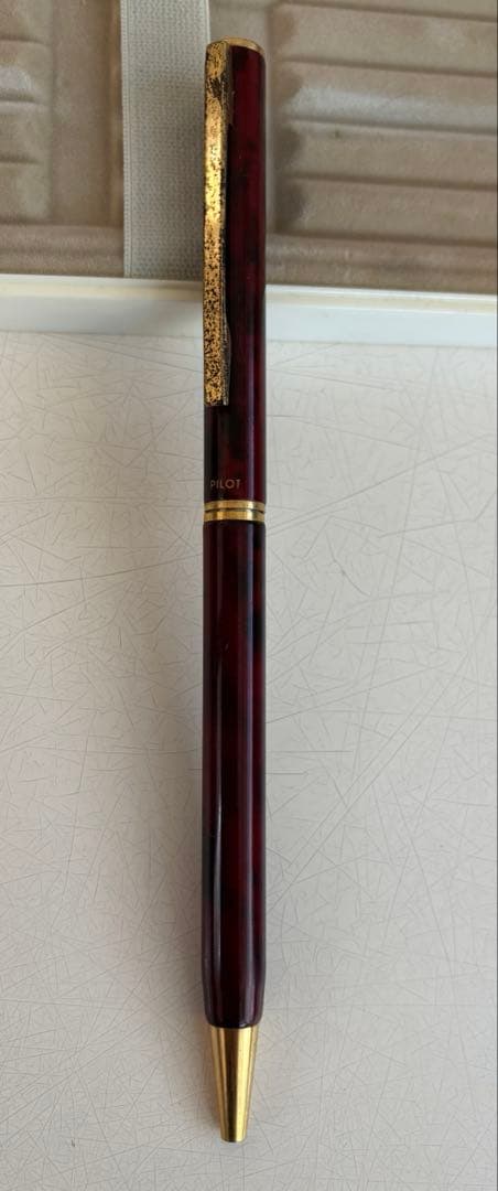 Set of 4 vintage PILOT Laureate ballpoint pens in pink, Bordeaux, and Bordeaux marble colors with visible aging