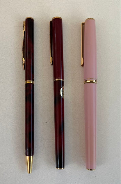 Set of 4 vintage PILOT Laureate ballpoint pens in pink, Bordeaux, and Bordeaux marble colors with visible aging