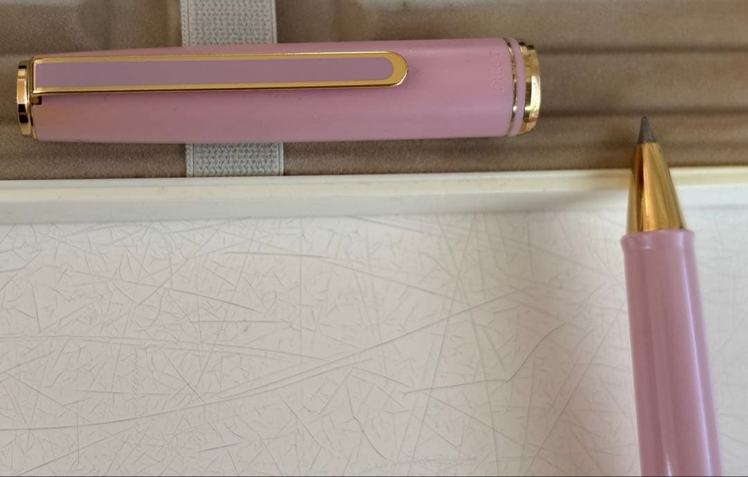 Set of 4 vintage PILOT Laureate ballpoint pens in pink, Bordeaux, and Bordeaux marble colors with visible aging