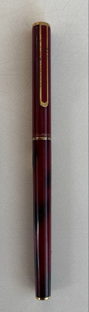 Set of 4 vintage PILOT Laureate ballpoint pens in pink, Bordeaux, and Bordeaux marble colors with visible aging