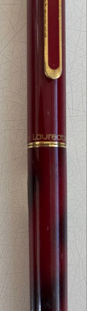 Set of 4 vintage PILOT Laureate ballpoint pens in pink, Bordeaux, and Bordeaux marble colors with visible aging