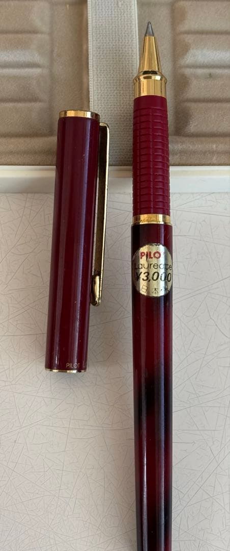 Set of 4 vintage PILOT Laureate ballpoint pens in pink, Bordeaux, and Bordeaux marble colors with visible aging