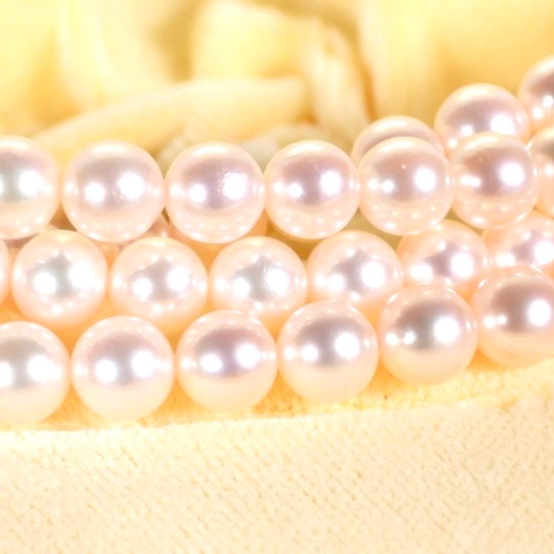Akoya genuine pearl long necklace featuring two rows of flower pearl inclusions on a white background