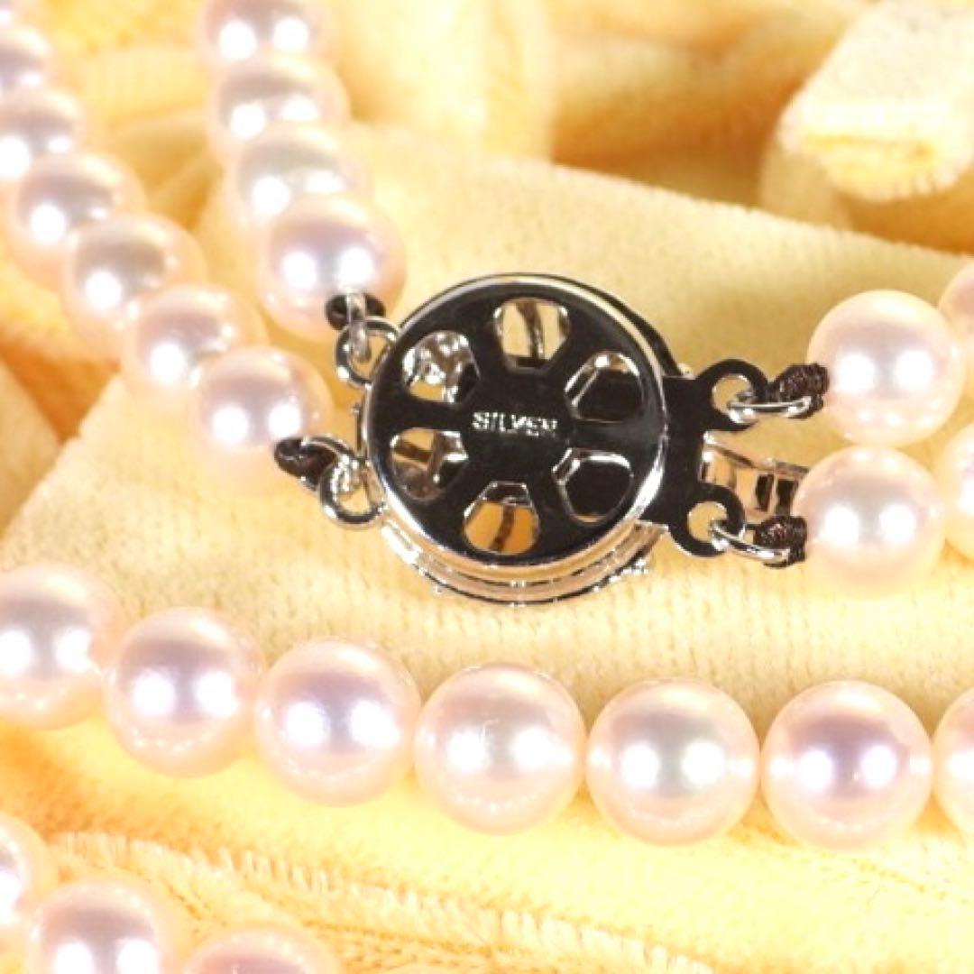 Akoya genuine pearl long necklace featuring two rows of flower pearl inclusions on a white background